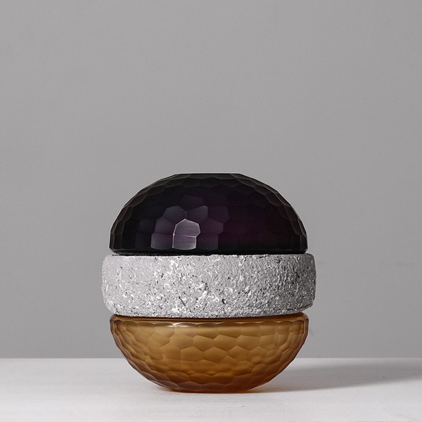 Flower arrangement in spherical glass vase