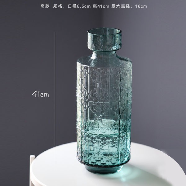 Embossed antique green glass vase